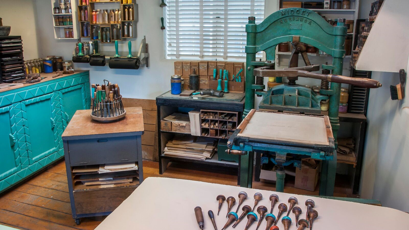 Gustave Baumann’s Midget Reliance press, carving tools and pigments. Photo by Blair Clark